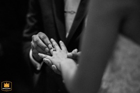 At the Garré Vineyard in Livermore, CA, an intimate and focused ceremony detail shot captures the groom's hand gently placing the wedding ring onto the bride's finger during the vows.